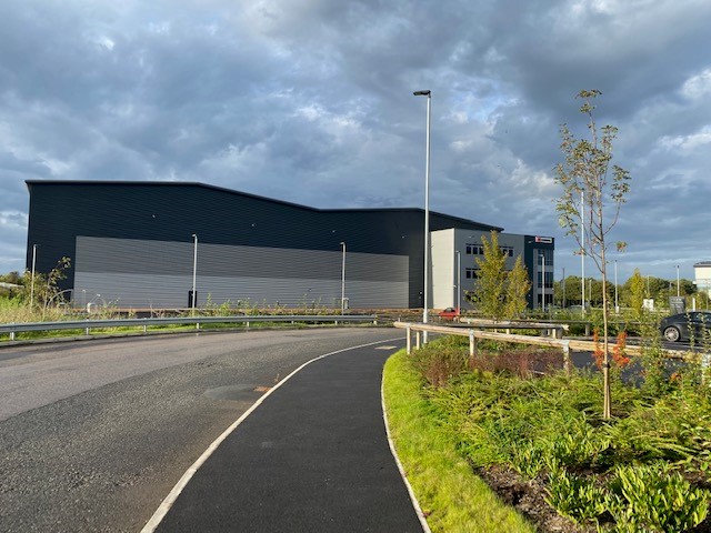 Large Industrial Building, Near Entrance Road, Large Grass plain to the right, Middlewich Phase 1, Pioneer Design & Build