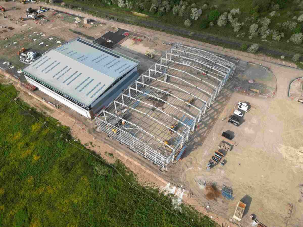 Aerial Shot of Industrial Building under Construction, Surrounded by Work yard and Grass Fields, Pioneer Design & Build